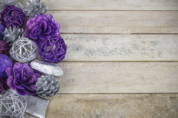 Group of purple and silver Christmas decoration on a wooden background with copyspace.