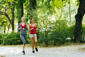 Sportive women jogging in park