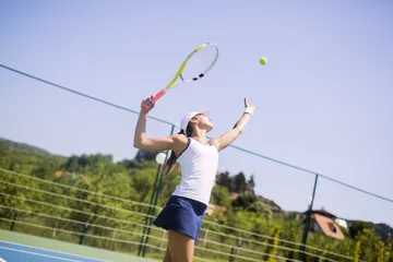 Fotobehang Beautiful female tennis player serving © NDABCREATIVITY