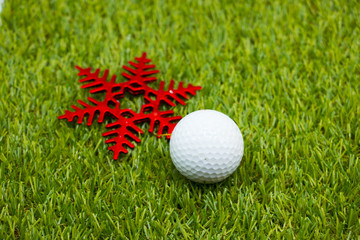 golf ball and Christmas ornament on green grass