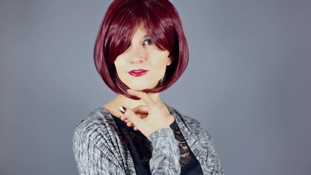 Female fashion model showing off new hairstyle or red hair color