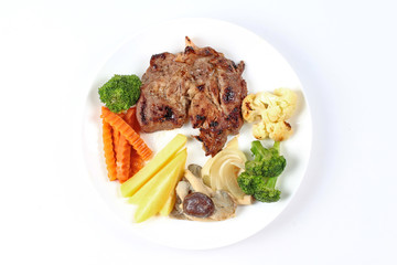Home made ,Pork steak and mixed vegetables served.