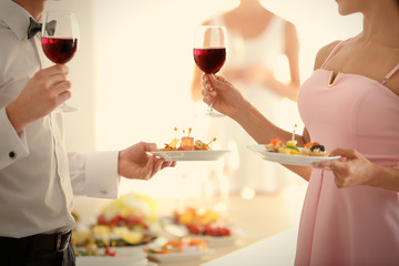 People with wine and snacks at buffet catering party, close up
