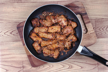 Ready grilled pork with mixed herb in pan  served.