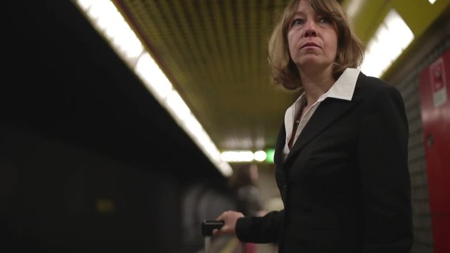Businesswoman waiting the train in the subway station