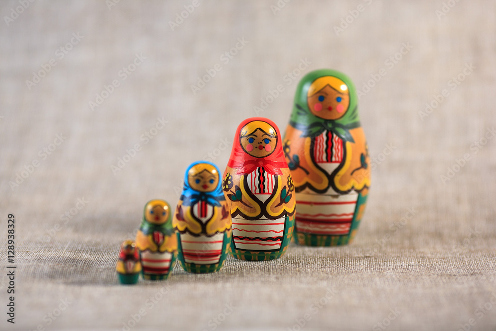 Wall mural Russian dolls. Matryoshka on linen fabric for the background.