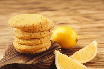 Composition of cookies and lemons on wooden background, closeup