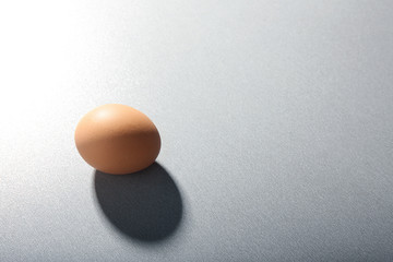 Raw egg on grey background
