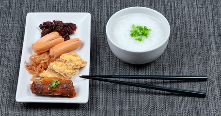 Rice gruel served with sausage ,clams,radish ,omelet and mackere
