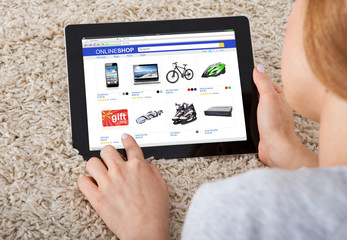 Close-up Of Woman Shopping On Digital Tablet