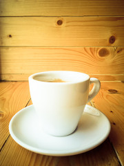 Cup of coffee on a shop old wood counter
