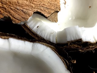 Jagged coconut pieces on a dark background © jlmcanally