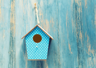 birdhouse on antique rustic wood background.