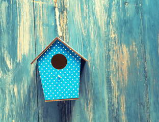 birdhouse on antique rustic wood background.