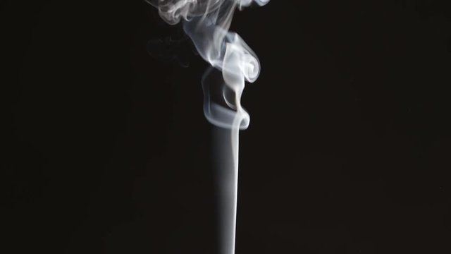Thin smoke stream on black background