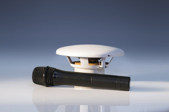 Black microphone and small white loudspeaker