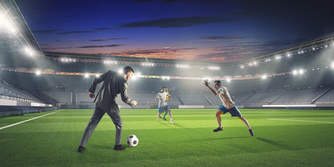 Businessman playing soccer . Mixed media