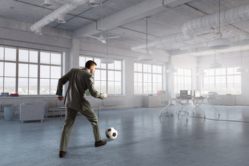 Playing office soccer . Mixed media