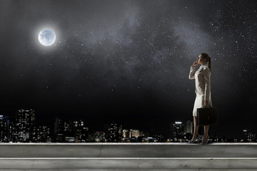 Fototapeta premium Businesswoman on building roof