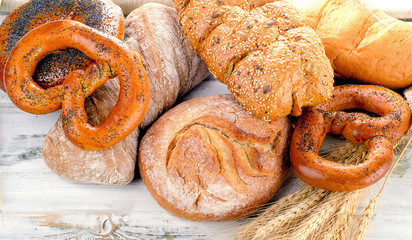 Different fresh bread on a wooden table