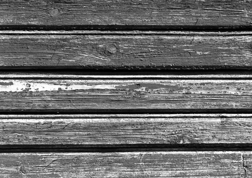 Weathered black and white color wooden house wall.