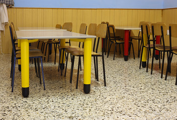 tables and colored chairs in a nursery school