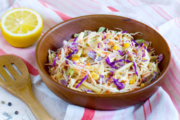 Salad coleslaw in a wooden bowl close-up, rustic style