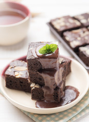 Chocolate Brownie with chocolate topping on white wood