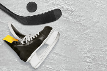 Black hockey stick, skates and the puck
