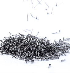 pile of metal nails on a white background