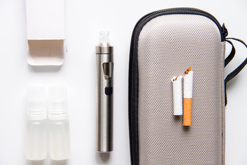 concept of electronic cigarette on white background top view