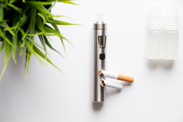 concept of electronic cigarette on white background top view