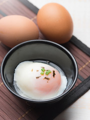 Soft boiled egg or onsen egg on wooden