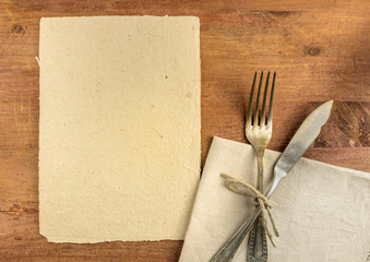 Parchment for copyspace, knife and fork on dinner table