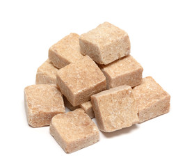 Brown sugar cube heap isolated on white background