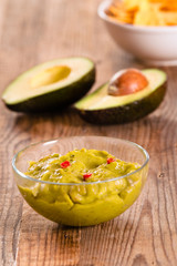 Guacamole dip and nacho chips.