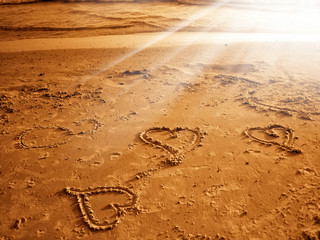 An image of heart shape drawing on the sand
