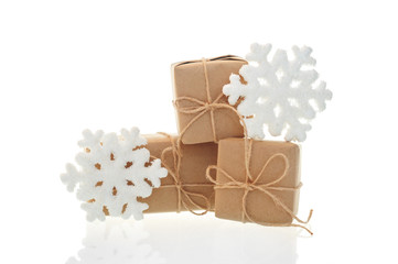 Holiday boxes and toy snowflakes on white background