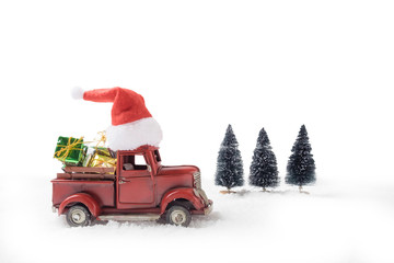 Christmas toy santa truck with gift boxes and pine tree on snow