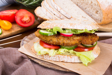 sandwich with fried meat and vegetables