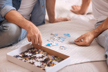 Fototapeta na wymiar Small box with puzzles lying on the bed