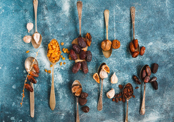 Food in spoons. Variety Of Dry Fruit Displayed 