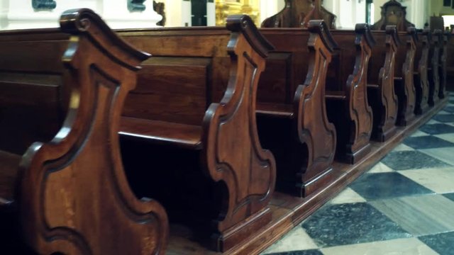 Old wooden benches in catholic church
