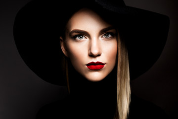 Woman with red lips and black hat