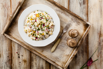Traditional German potato salad with cucumber, onion and mayonna