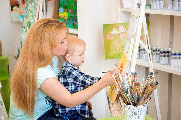 Mother and child draw a picture paints, art lesson