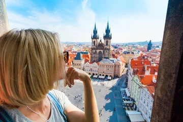 No drill roller blinds Prague Kostel Panny Marie pred Tynem. Church of the Virgin Mary. A young woman stands on top of the clock tower and looks at the Old Town Square in Prague