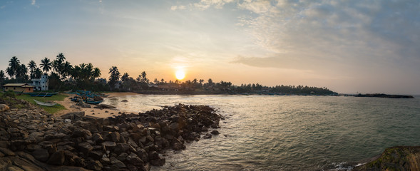 Beautiful sunrise at the Indian Ocean coast on Kumarakanda Fishery Harbor in Sri Lanka