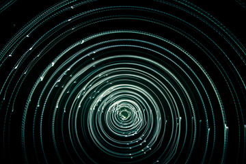 Colorful abstract trails of light. Dots, lines and bokeh on dark background. Long exposure.