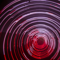 Colorful abstract trails of light. Dots, lines and bokeh on dark background. Long exposure.